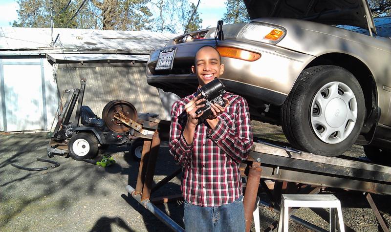 Philip with the starter out, standing in front of the car.